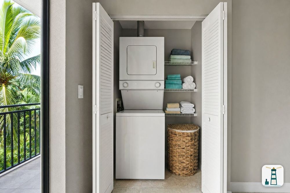 Stacked washer and dryer in a condo laundry closet