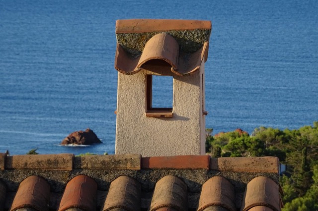 Masonry chimney rising above a home's roofline — Chimney Masonry & Tuckpointing in Pompano Beach, FL