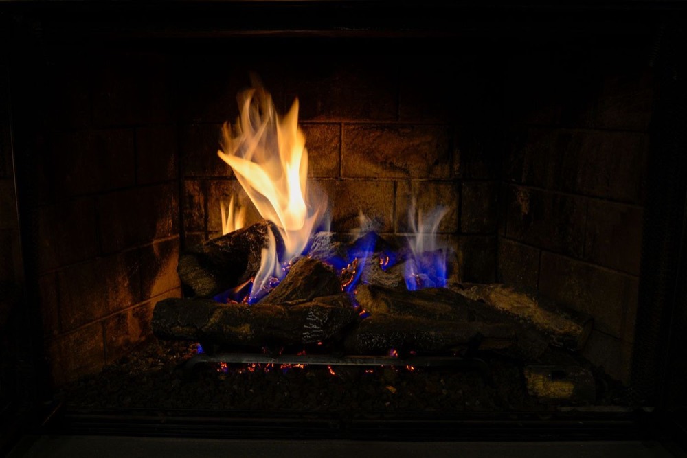 Gas fireplace burning with a steady flame — Your Local Chimney Team · Pompano Beach, FL