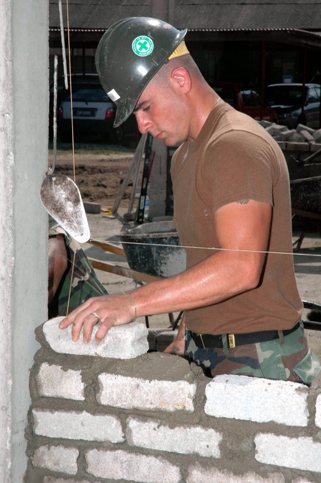 Brick courses being rebuilt on a chimney stack — Chimney Rebuild in Pompano Beach, FL