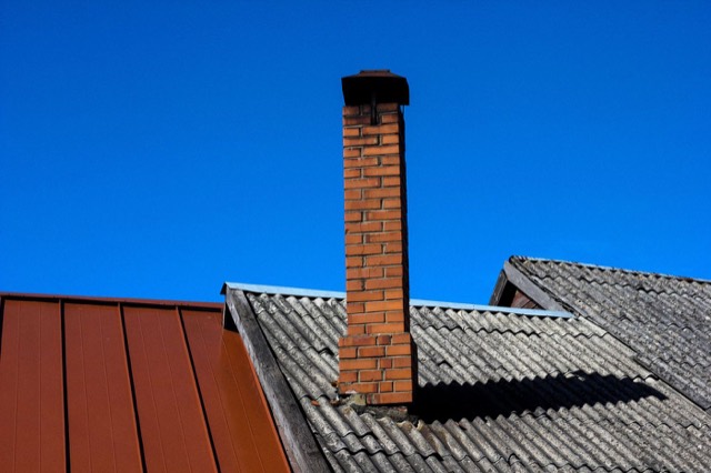 Rooftop view of a chimney above the shingle line — Chimney Sweep in Pompano Beach, FL